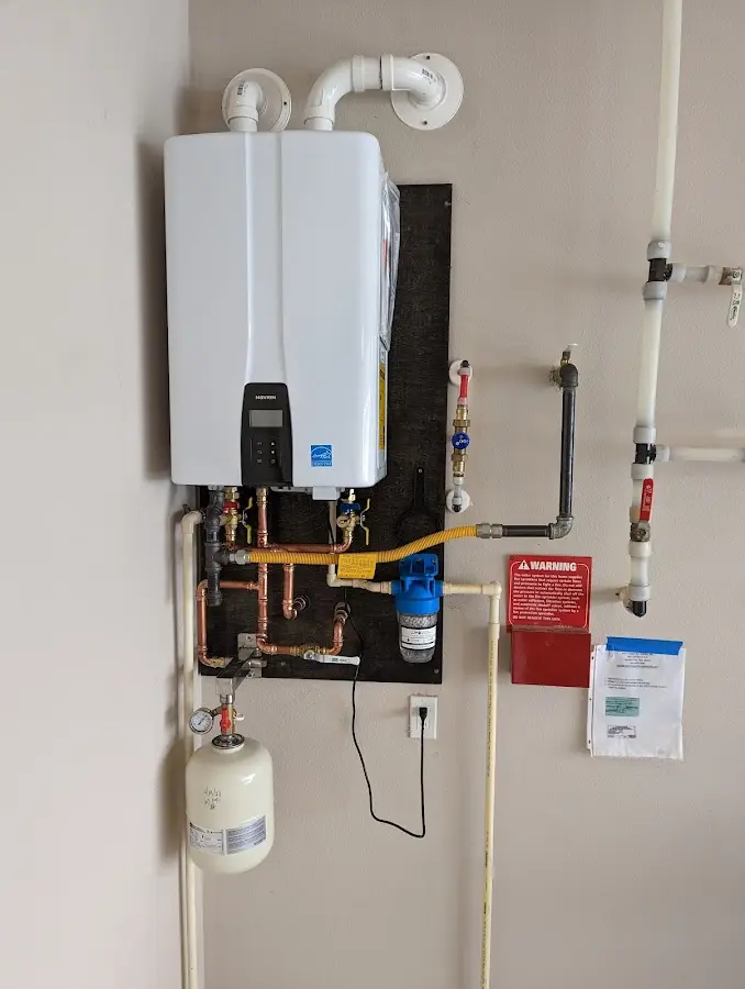 Professional plumber installing copper piping in a Celebration home